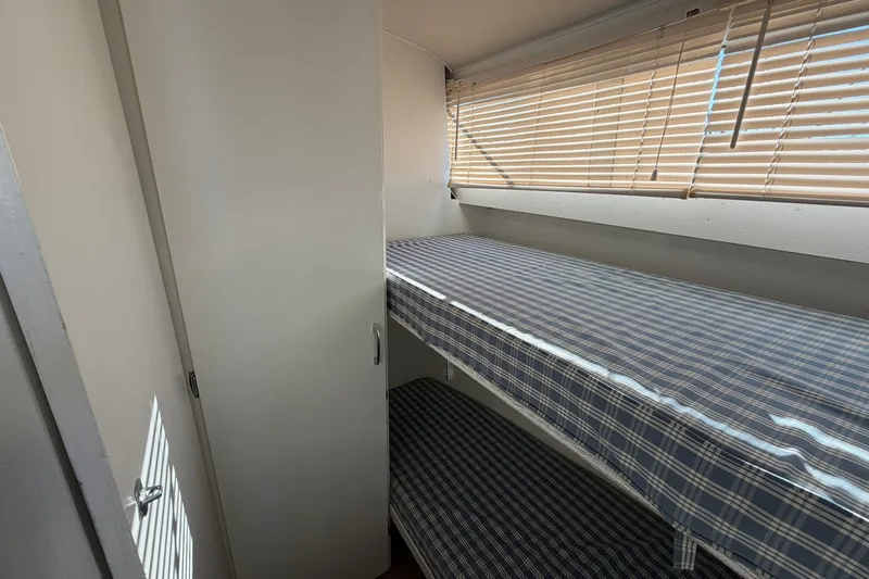 Slide: The Image of Interior of 1973 Chris-Craft 31 Sedan Cruiser with bunk beds and window blinds. - 58