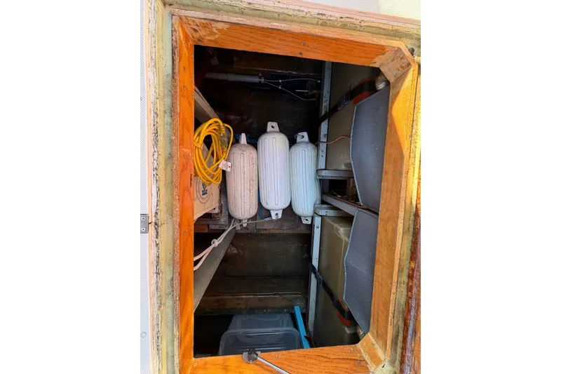 Slide: The Image of Storage compartment of a 1973 Chris-Craft 31 Sedan Cruiser with fenders and cables. - 15
