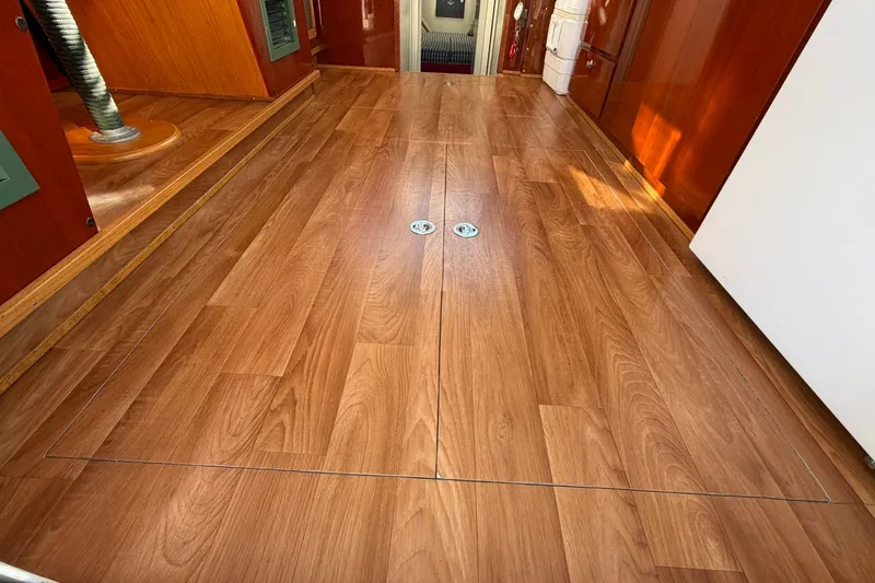 Slide: The Image of Interior view of 1973 Chris-Craft 31 Sedan Cruiser with polished wooden flooring. - 27