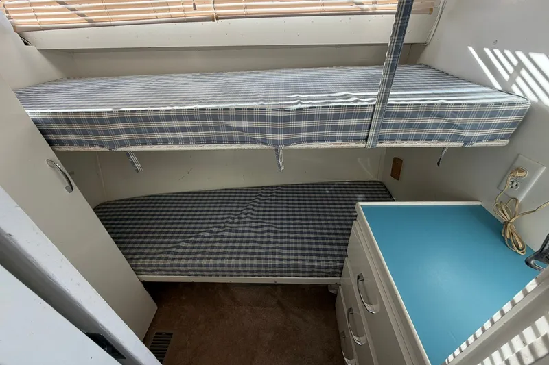Slide: The Image of Interior of 1973 Chris-Craft 31 Sedan Cruiser with bunk beds and blue checkered bedding. - 56
