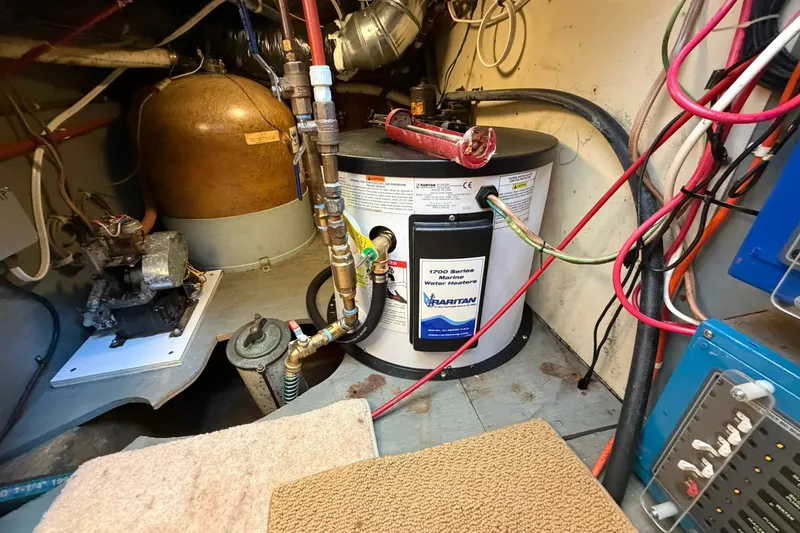 Slide: The Image of Engine room of 1973 Chris-Craft 31 Sedan Cruiser with marine water heater and wiring. - 67