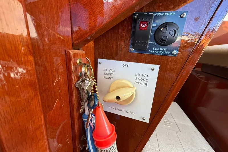 Slide: The Image of 1973 Chris-Craft 31 Sedan Cruiser control panel with keys and bilge alert system. - 46