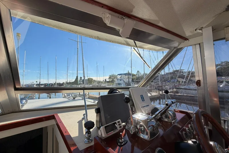 Slide: The Image of Interior view of 1973 Chris-Craft 31 Sedan Cruiser cockpit with marina backdrop. - 59