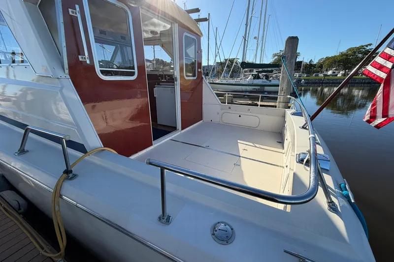 Slide: The Image of 1973 Chris-Craft 31 Sedan Cruiser docked, showcasing spacious deck and classic design. - 10