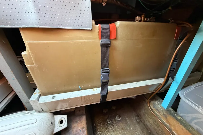 Slide: The Image of 1973 Chris-Craft 31 Sedan Cruiser engine compartment with secured fuel tank and visible wiring. - 19