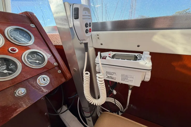 Slide: The Image of 1973 Chris-Craft 31 Sedan Cruiser dashboard with gauges and marine radio equipment. - 38