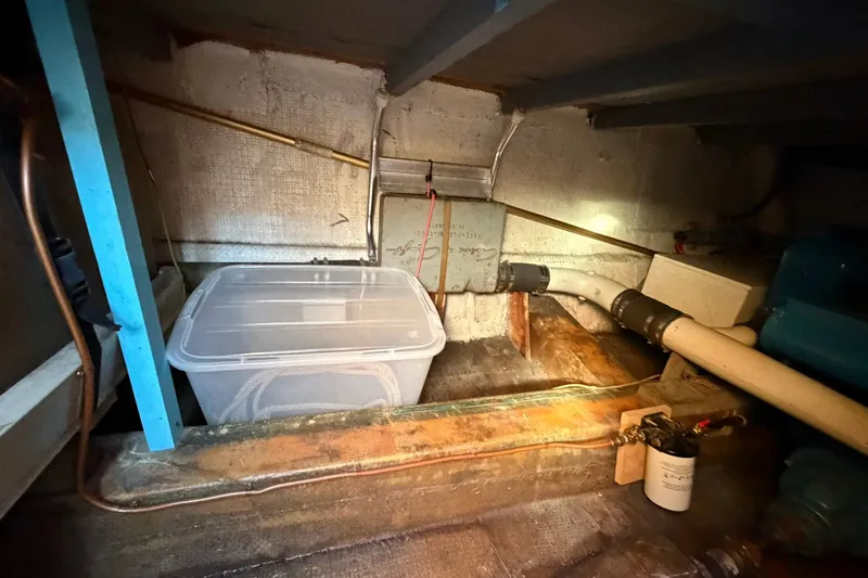 Slide: The Image of Engine compartment of 1973 Chris-Craft 31 Sedan Cruiser with storage container and piping. - 20