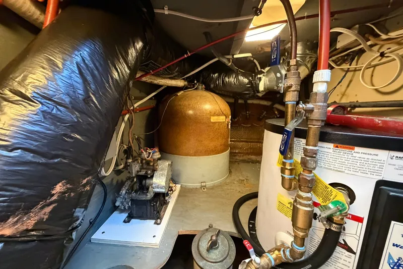 Slide: The Image of Engine room of a 1973 Chris-Craft 31 Sedan Cruiser with mechanical components and piping. - 69