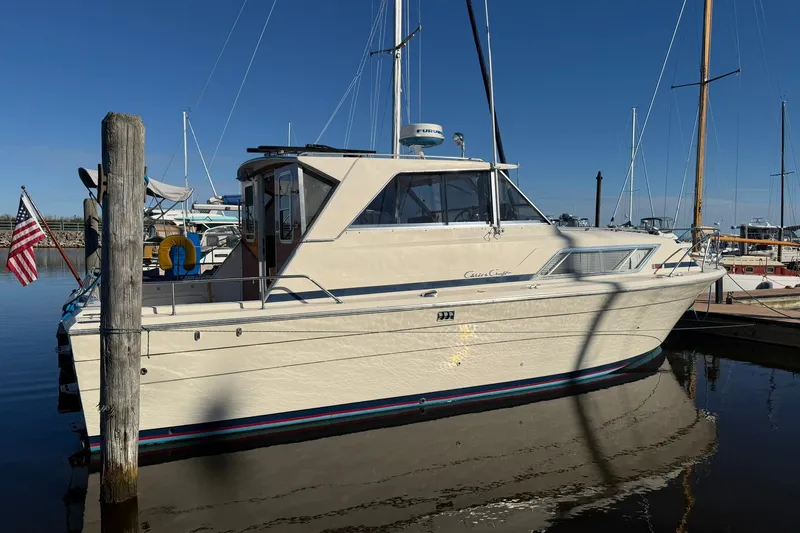 Slide: The Image of 1973 Chris-Craft 31 Sedan Cruiser docked at marina under clear blue sky. - 2