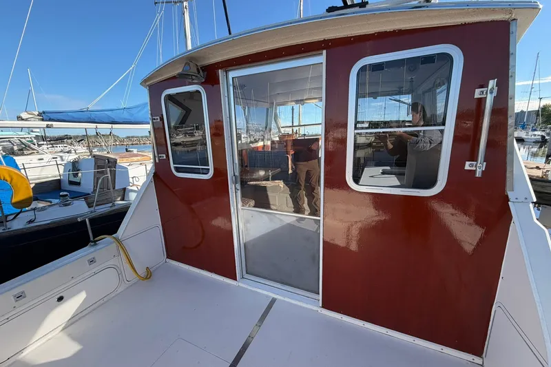 Slide: The Image of 1973 Chris-Craft 31 Sedan Cruiser with red cabin, docked at marina. - 12