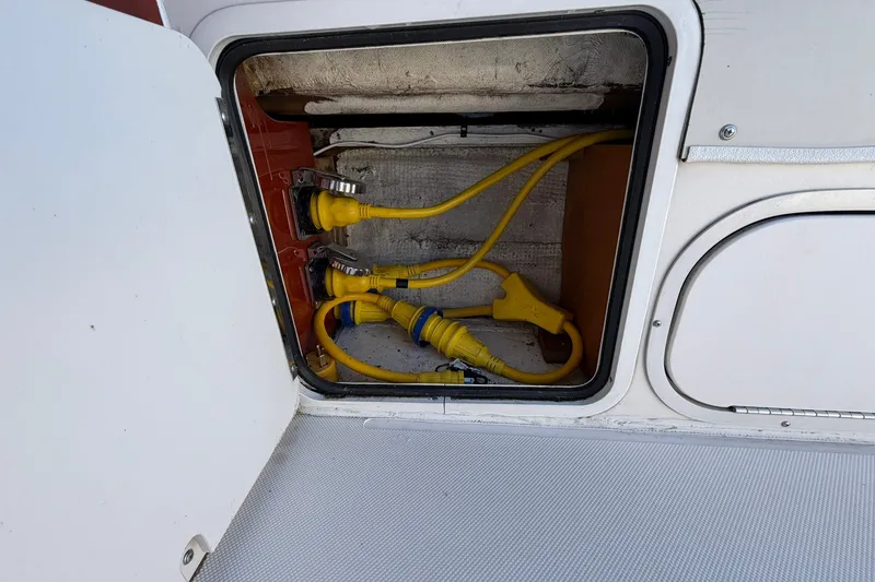 Slide: The Image of Electrical compartment of a 1973 Chris-Craft 31 Sedan Cruiser with yellow power cables. - 14