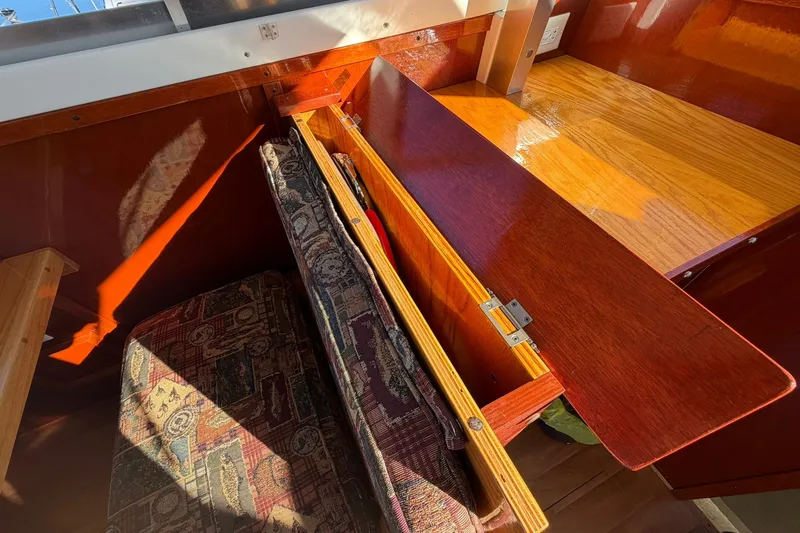 Slide: The Image of Interior of 1973 Chris-Craft 31 Sedan Cruiser with wooden storage compartment and patterned upholstery. - 31