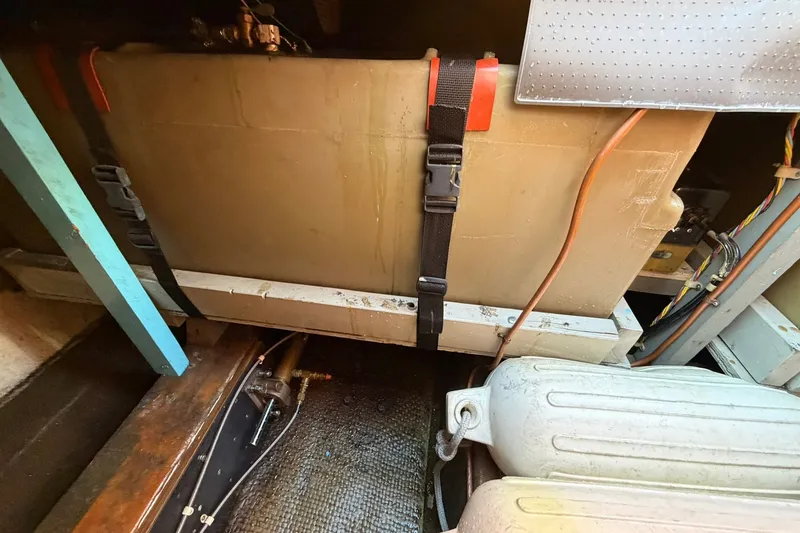 Slide: The Image of Engine compartment of 1973 Chris-Craft 31 Sedan Cruiser with visible fuel tank and components. - 18