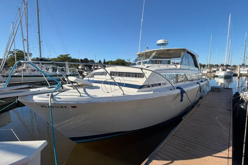 Slide: The Image of 1973 Chris-Craft 31 Sedan Cruiser docked at marina under clear blue sky. - 4