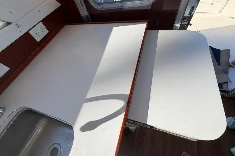Slide: The Image of 1973 Chris-Craft 31 Sedan Cruiser interior with sink and foldable table. - 33