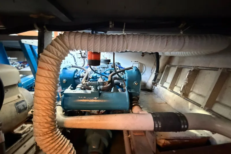 Slide: The Image of Engine room of a 1973 Chris-Craft 31 Sedan Cruiser with visible blue engine components. - 25