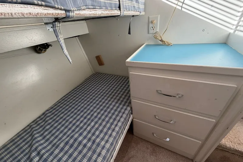 Slide: The Image of 1973 Chris-Craft 31 Sedan Cruiser interior with bunk bed and storage drawers. - 57