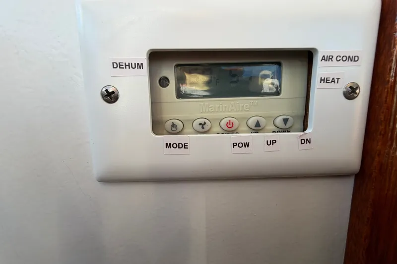 Slide: The Image of Thermostat control panel on 1973 Chris-Craft 31 Sedan Cruiser, featuring various mode settings. - 47
