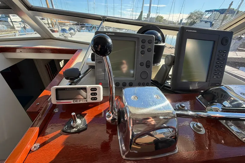 Slide: The Image of 1973 Chris-Craft 31 Sedan Cruiser dashboard with navigation equipment and depth gauge. - 39