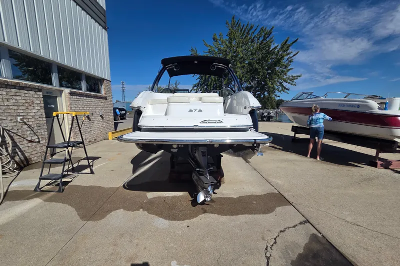 Slide: The Image of 2005 Cobalt 272 boat on a dock, sunny day, person nearby. - 23