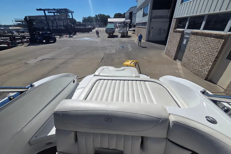 Slide: The Image of 2005 Cobalt 272 boat interior at a marina with industrial background. - 13