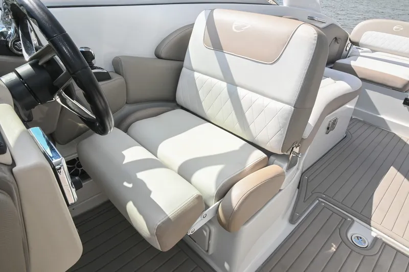 Slide: The Image of 2020 Crownline Eclipse E305 XS boat interior with luxurious seating and steering wheel. - 37