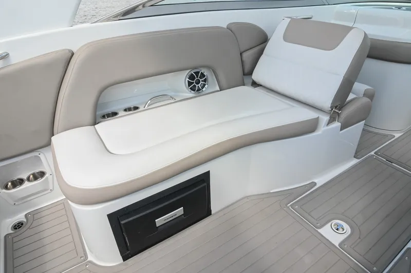 Slide: The Image of 2020 Crownline Eclipse E305 XS boat interior with beige seating and cup holders. - 27