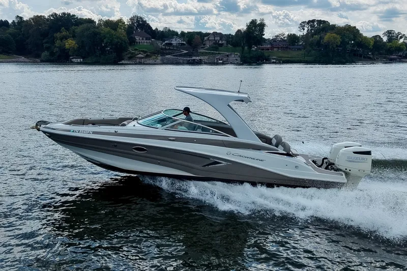 Slide: The Image of 2020 Crownline Eclipse E305 XS boat cruising on a scenic lake. - 54