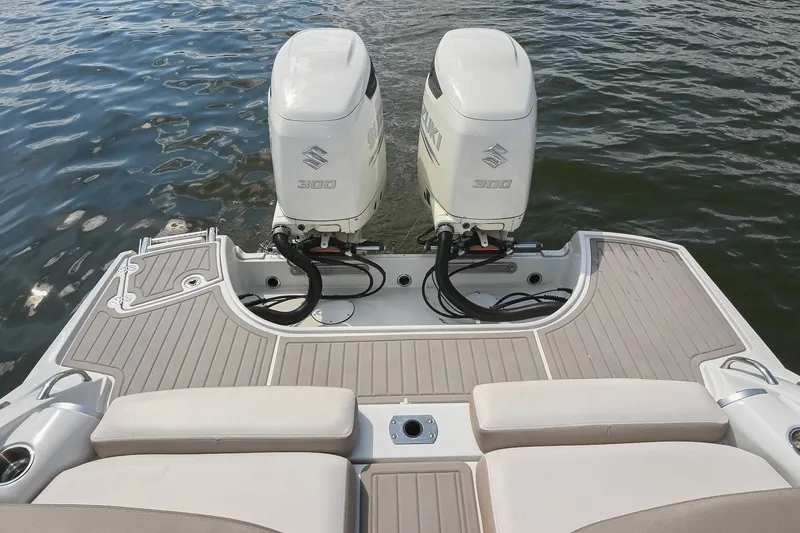 Slide: The Image of 2020 Crownline Eclipse E305 XS boat with twin Suzuki 300 outboard engines on water. - 18