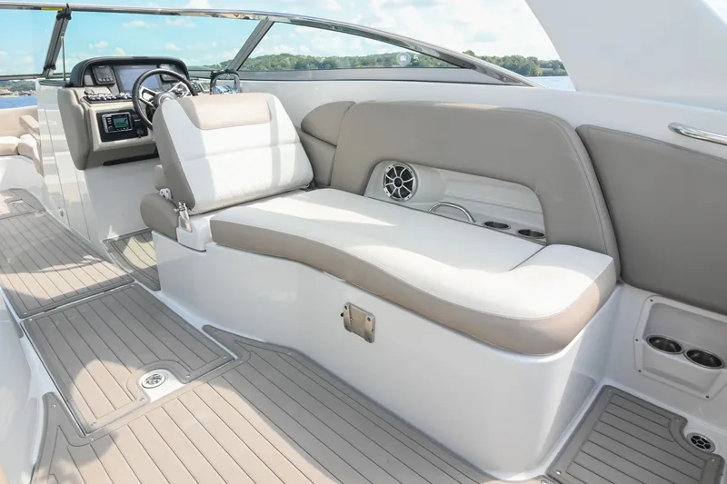 Slide: The Image of 2020 Crownline Eclipse E305 XS boat interior with plush seating and modern dashboard. - 29