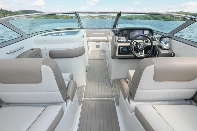 Slide: The Image of 2020 Crownline Eclipse E305 XS boat interior with modern dashboard and seating on a lake. - 32