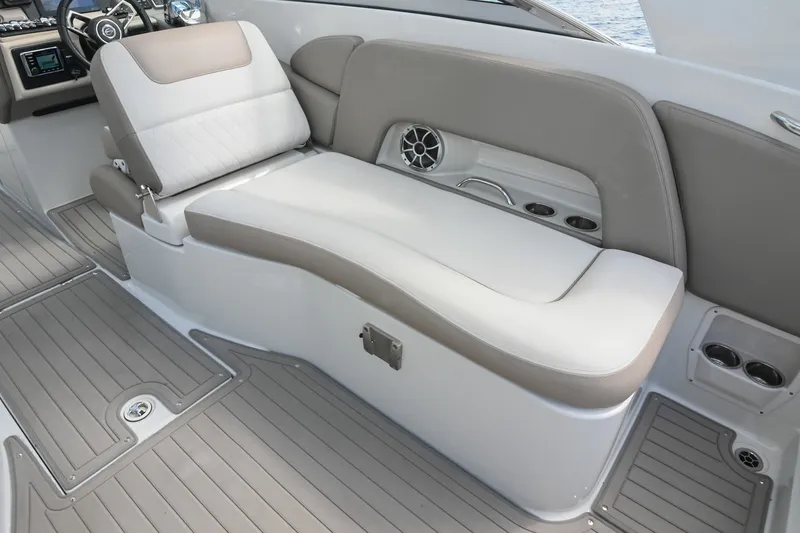 Slide: The Image of 2020 Crownline Eclipse E305 XS boat interior with beige seating and modern dashboard. - 30