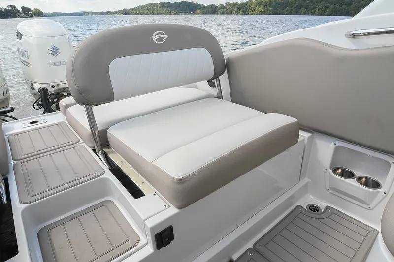 Slide: The Image of 2020 Crownline Eclipse E305 XS boat interior with cushioned seating and Suzuki outboard motor. - 22