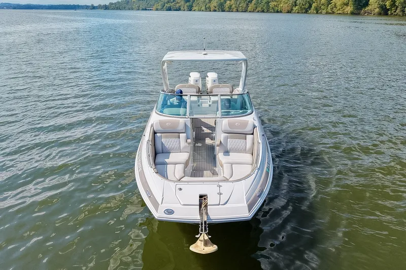 Slide: The Image of 2020 Crownline Eclipse E305 XS boat on calm lake waters. - 13