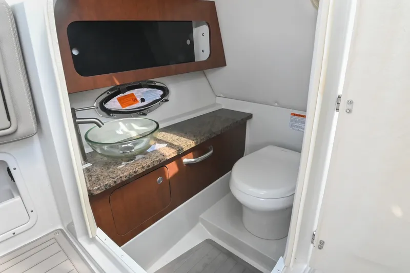 Slide: The Image of 2020 Crownline Eclipse E305 XS boat bathroom with glass sink and granite countertop. - 35