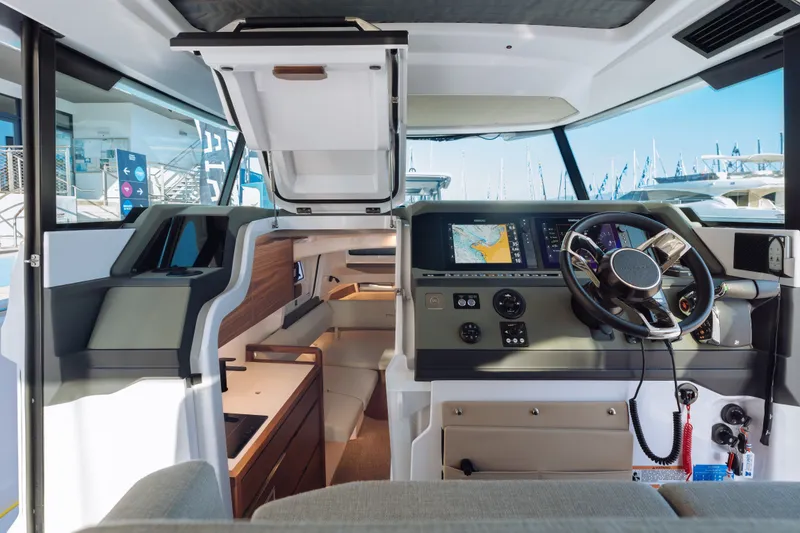 Slide: The Image of Interior view of 2027 Axopar 38 XC Cross Cabin with modern navigation system and steering wheel. - 15