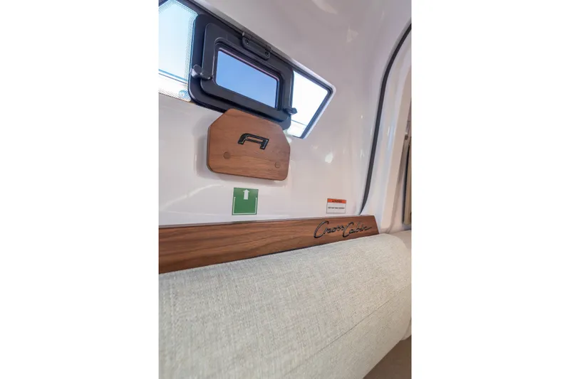 Slide: The Image of Interior detail of 2027 Axopar 38 XC Cross Cabin, featuring window and wooden accents. - 20