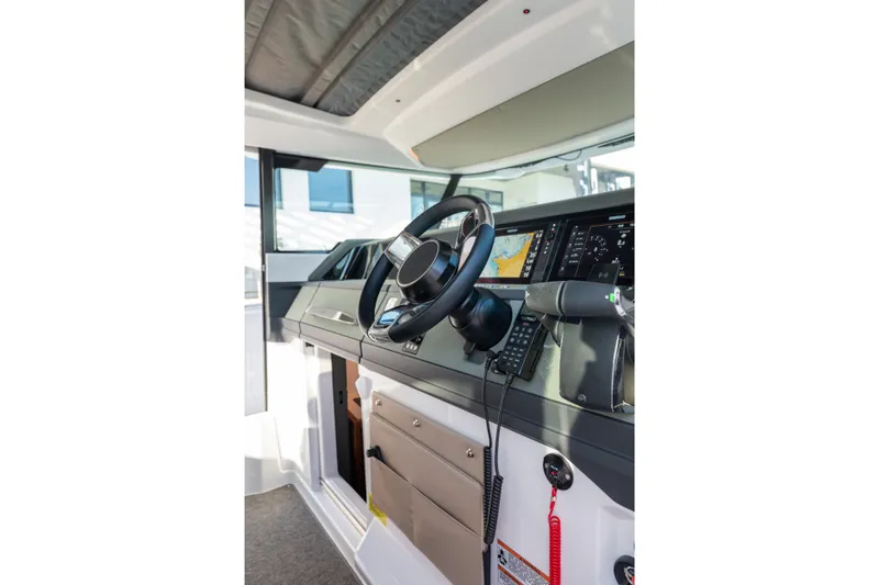 Slide: The Image of 2027 Axopar 38 XC Cross Cabin helm with modern navigation and control systems. - 16
