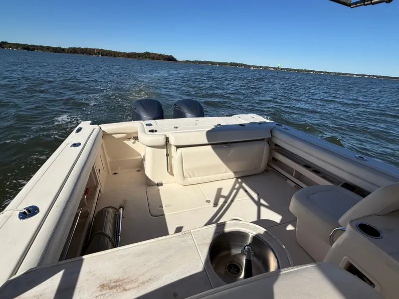 Slide: The Image of The image shows the cockpit of a Grady-White Freedom 307 boat on calm waters. - 39