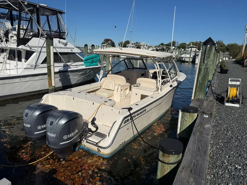 Slide: The Image of 2015 Grady-White Freedom 307 docked, featuring twin Yamaha engines and an open cockpit. - 4