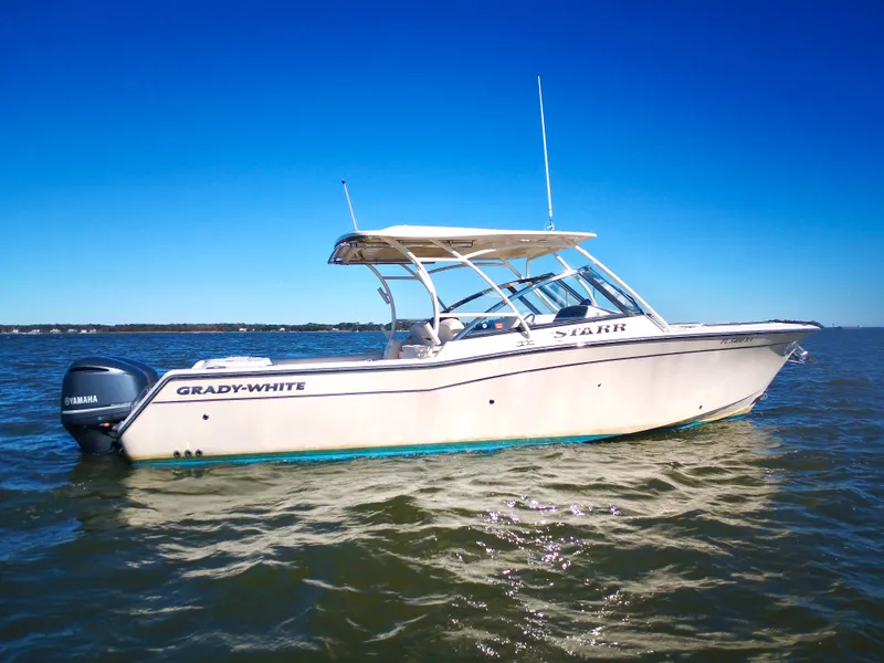 Slide: The Image of A 2015 Grady-White Freedom 307 boat on calm water under a clear sky. - 1