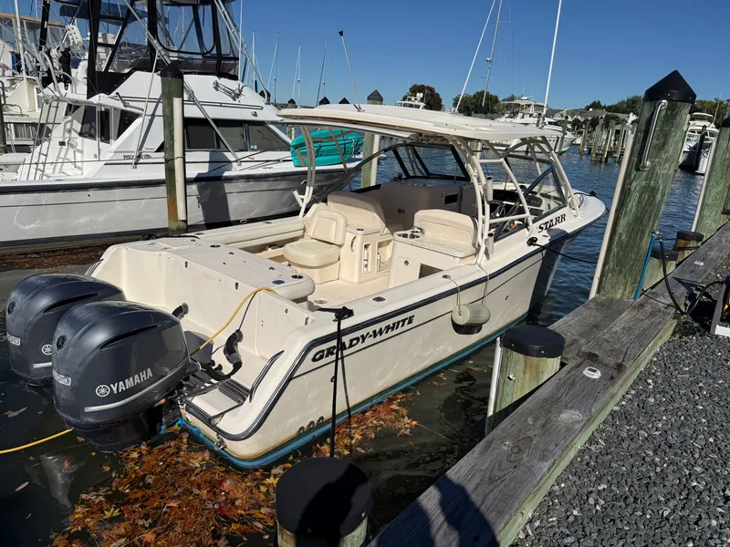Slide: The Image of 2015 Grady-White Freedom 307 docked, featuring twin Yamaha engines and a spacious cockpit. - 40