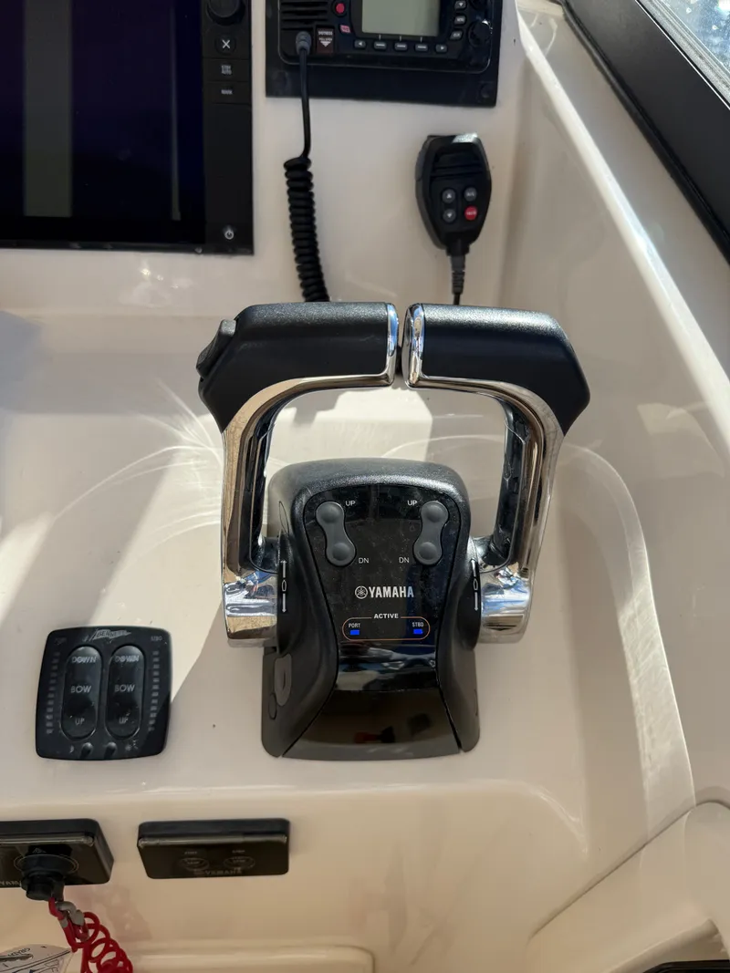 Slide: The Image of Close-up of the helm console on a Grady-White Freedom 307 boat with Yamaha throttle controls. - 37