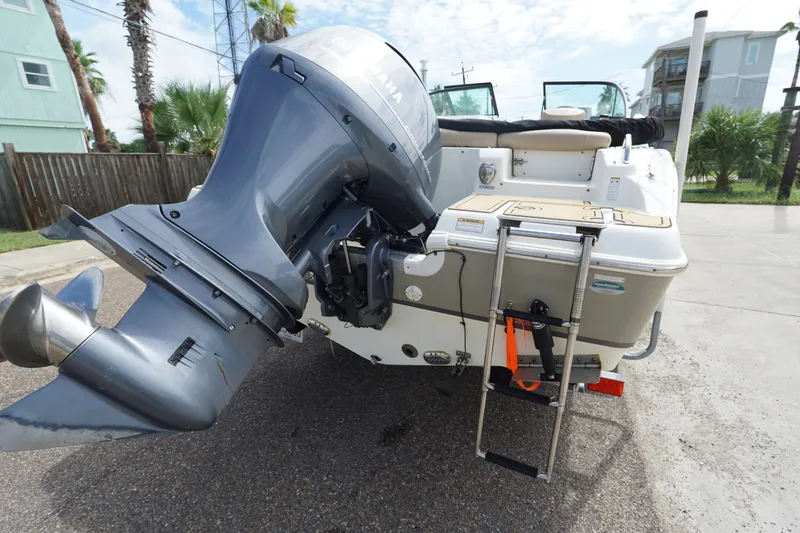 Slide: The Image of 2020 NauticStar 2302 Legacy Dual Console boat with Yamaha outboard motor and swim ladder. - 7