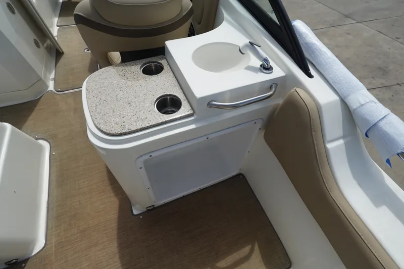 Slide: The Image of 2020 NauticStar 2302 Legacy Dual Console interior with sink and cup holders. - 20