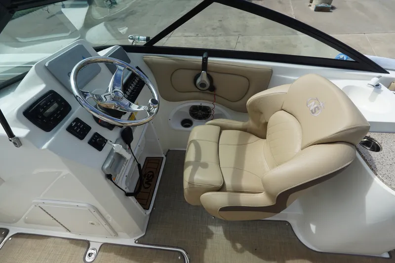 Slide: The Image of 2020 NauticStar 2302 Legacy Dual Console boat interior with steering wheel and beige captain's chair. - 15
