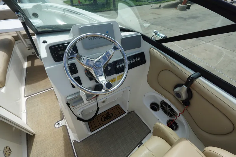 Slide: The Image of 2020 NauticStar 2302 Legacy Dual Console boat interior with steering wheel and controls. - 14