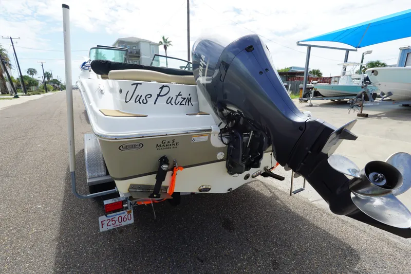 Slide: The Image of 2020 NauticStar 2302 Legacy Dual Console boat with outboard motor on a street. - 8
