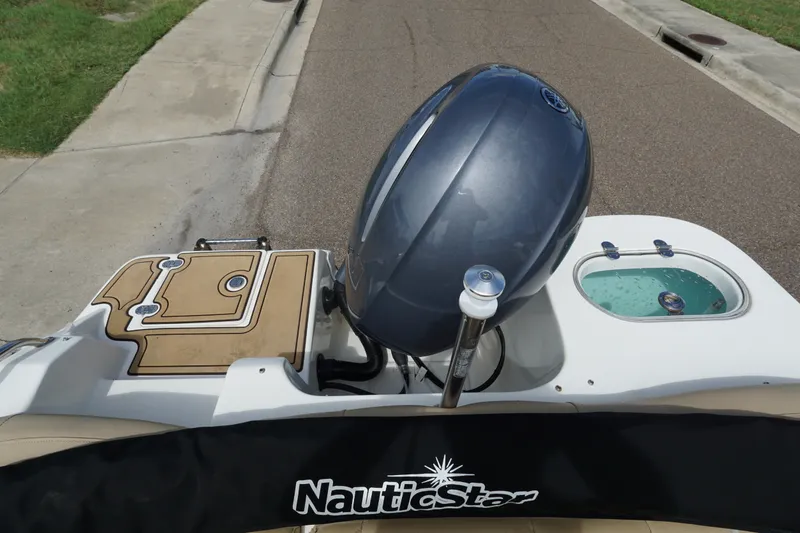 Slide: The Image of 2020 NauticStar 2302 Legacy Dual Console boat with motor and deck view. - 19