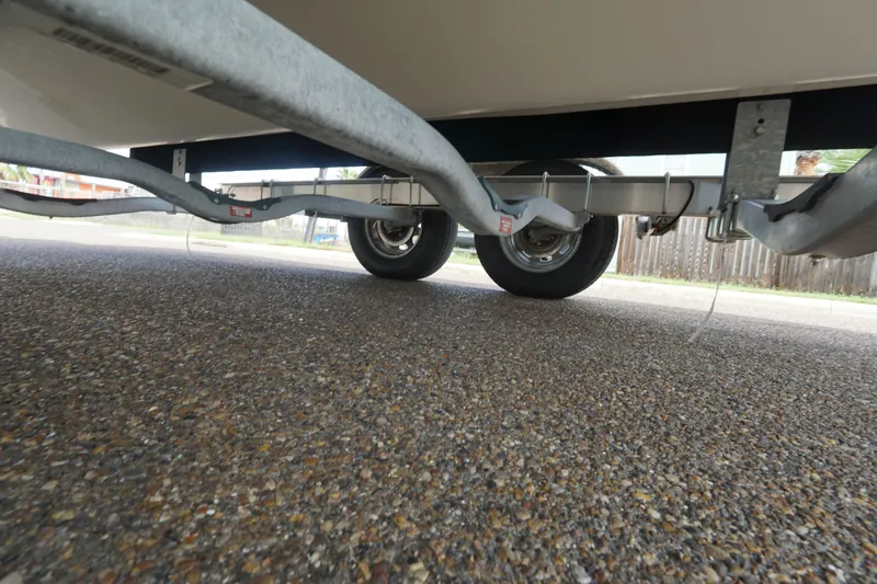 Slide: The Image of Underneath view of a 2020 NauticStar 2302 Legacy Dual Console on a trailer. - 10